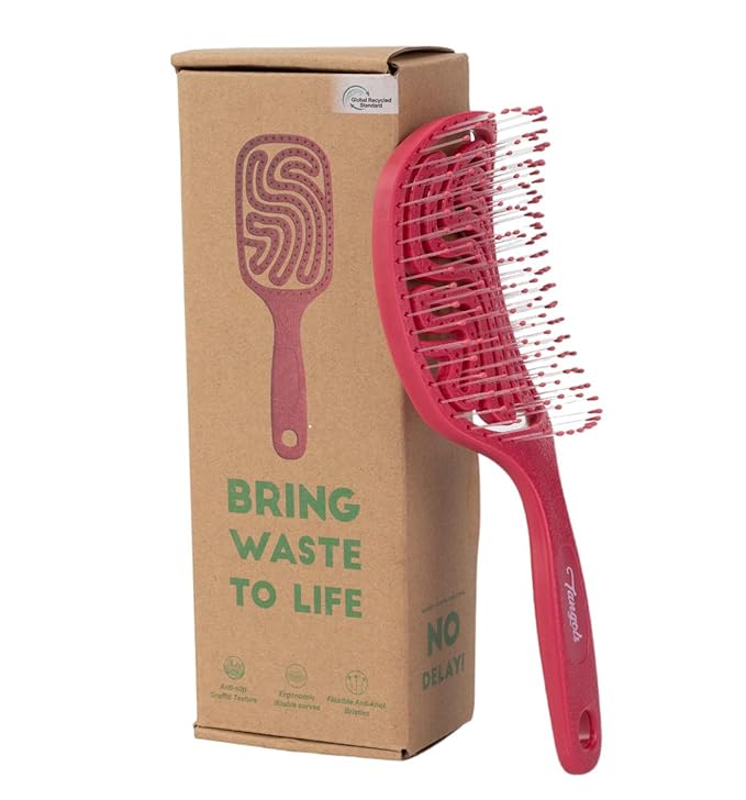 Red hairbrush in eco-friendly packaging with a 'Bring Waste to Life' slogan