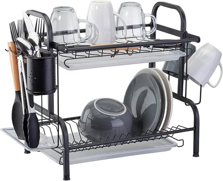 Black dish rack fully loaded with dishes and utensils