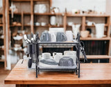 Black dish rack on a wooden kitchen counter