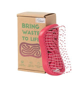 Red hairbrush packaged in a 'Bring Waste to Life' recyclable box