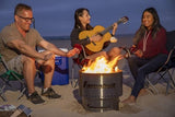 Beach party around a Fahrenheit fire pit with guitar