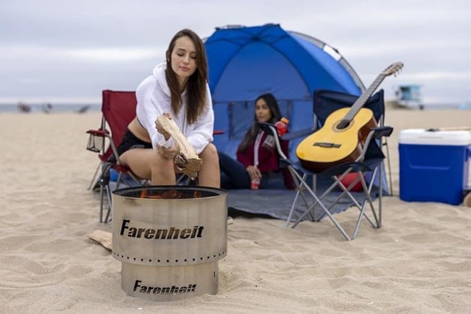 Woman preparing firewood at a Fahrenheit beach fire pit