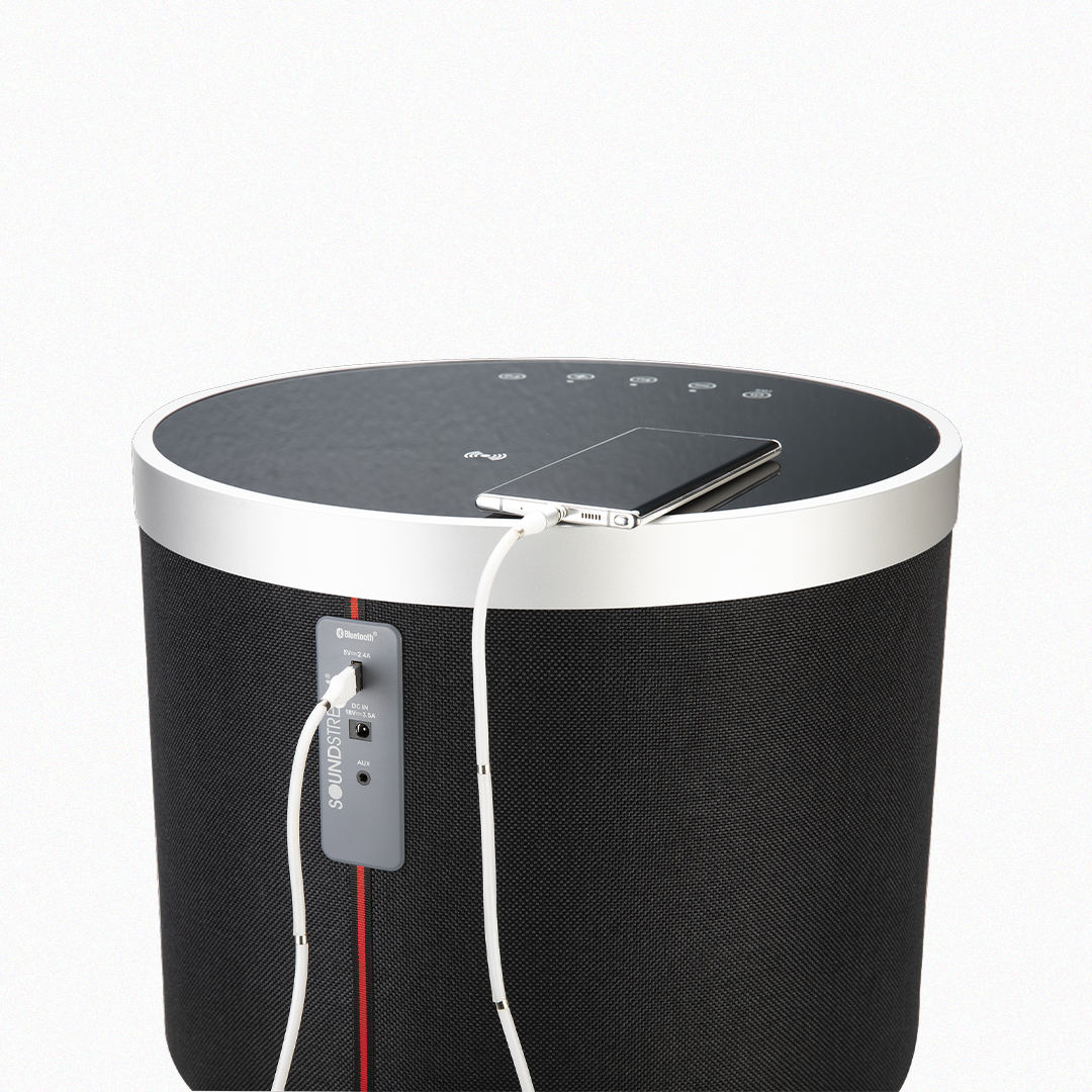 Black Soundstream speaker table charging a smartphone