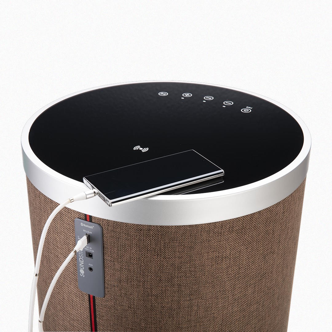 Brown Soundstream speaker table charging a smartphone on top